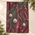 Christmas Pine Branch tea towel hanging over string against cream background with evergreen