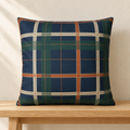 Navy plaid pillow styled on an oak bench