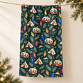 Retro Camp Christmas tea towel hanging over string against cream background with evergreen