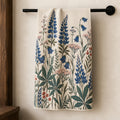 Blue lupine and bellflower tea towel hanging from a black towel rail