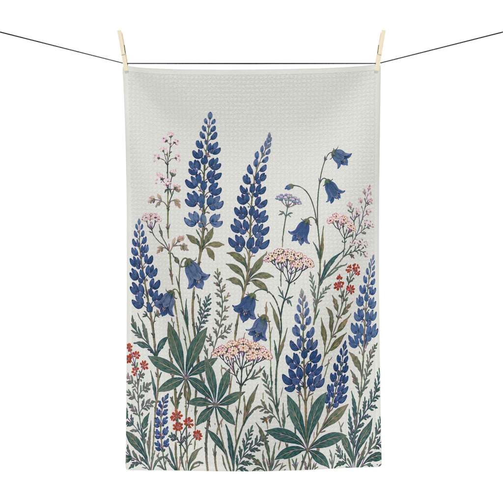 Lupine and bellflower tea towel clipped to a clothesline on a white background