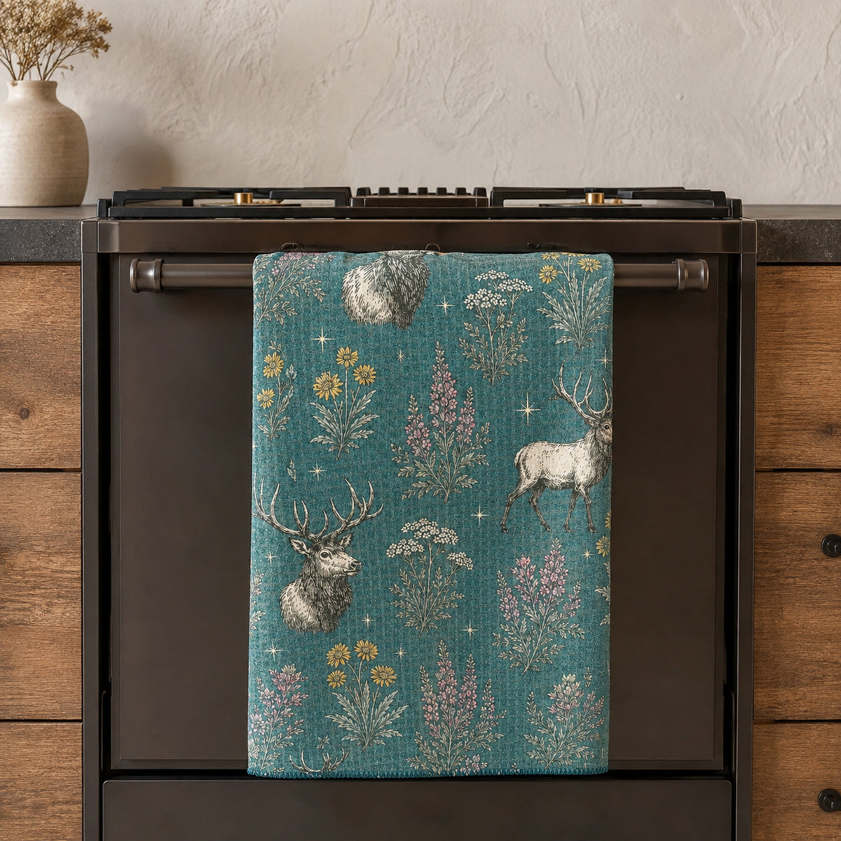 Elk and Wildflower tea towel hanging from an oven handle