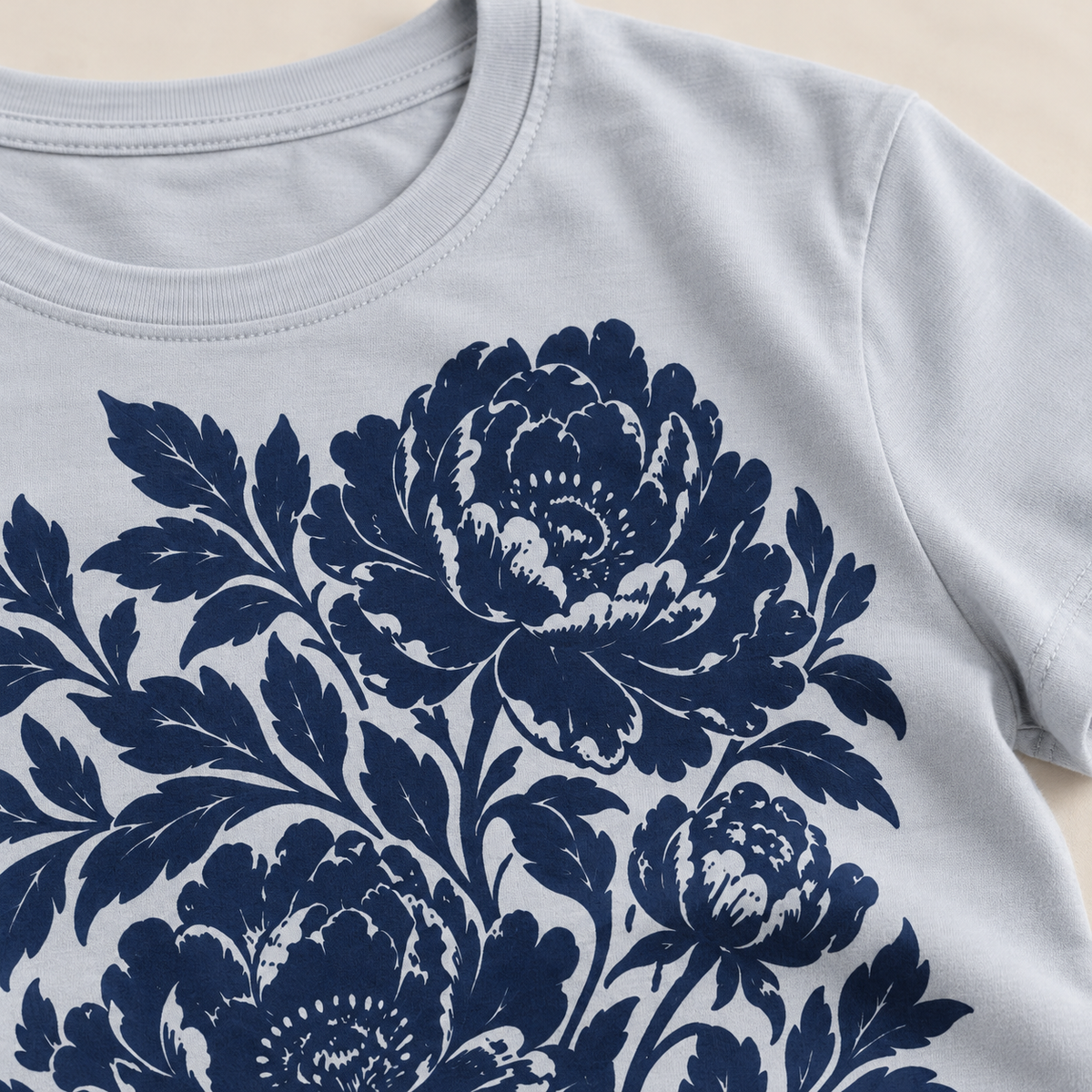 Powder blue cotton tee with navy peony print — print and fabric close-up