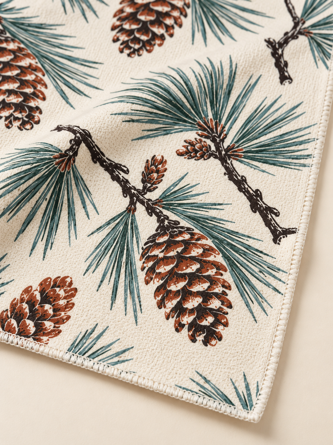 Ponderosa Pines and Cones tea towel — fabric detail, subtle waffle texture and matching overlocked edges
