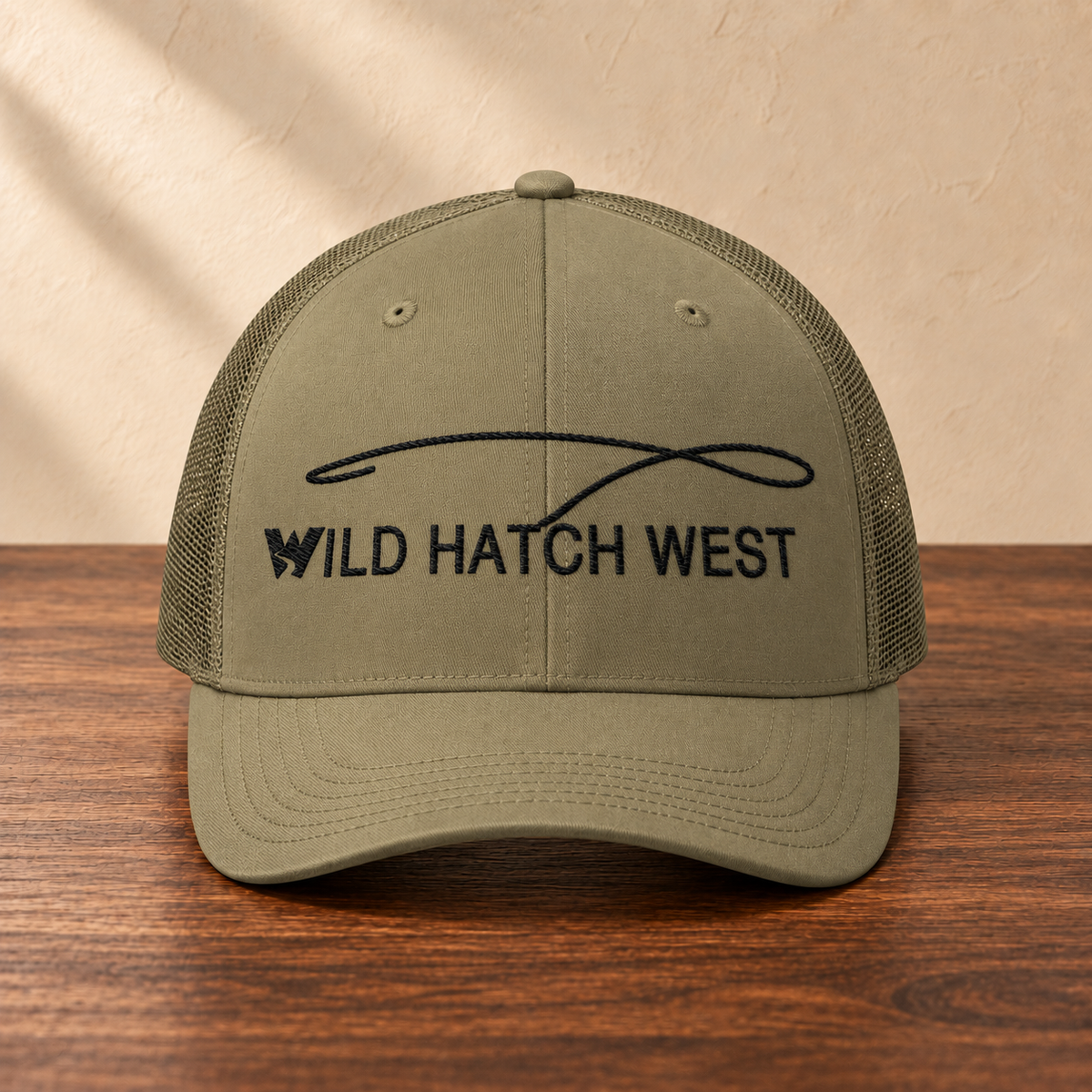 Wild Hatch West Fly Fishing Hat, front studio view on dark wood against a cream wall