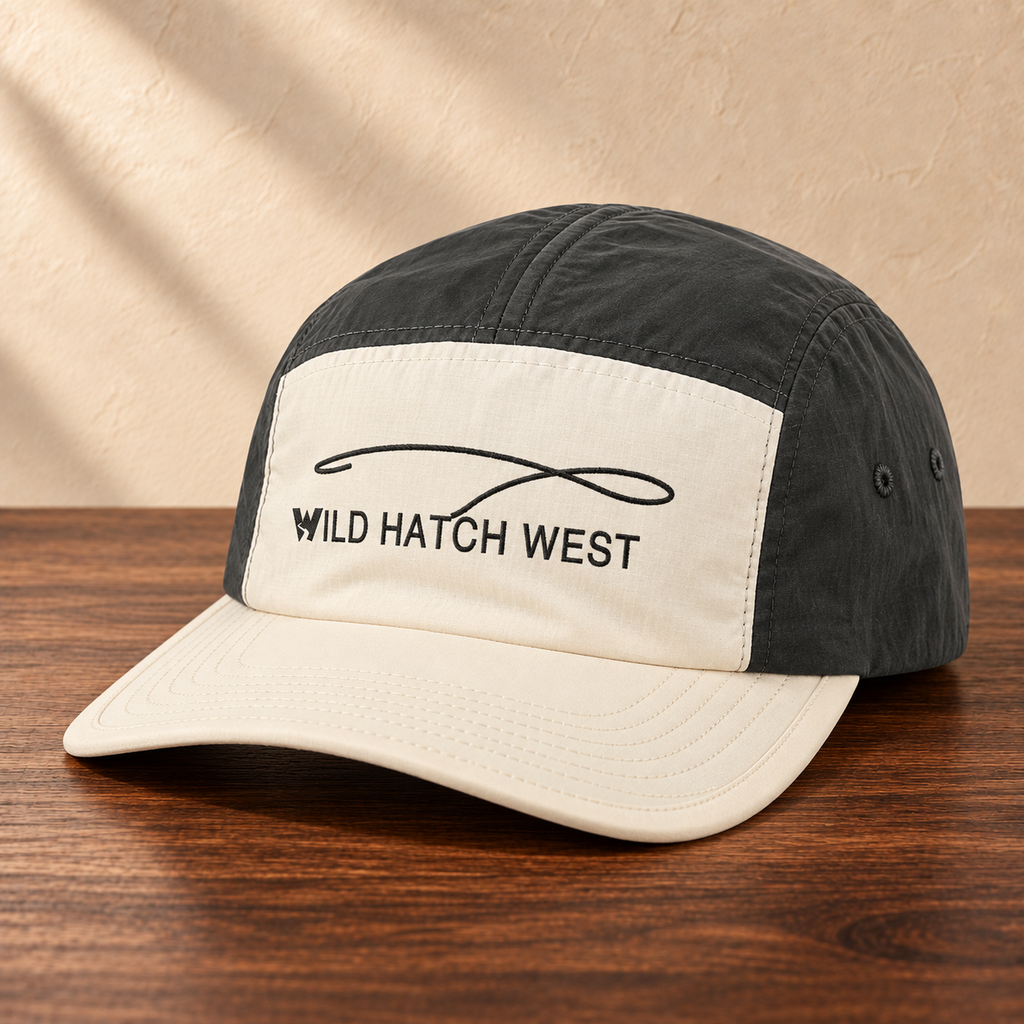 Finn Two-Tone Nylon Cap, angled studio view on dark wood against a cream wall